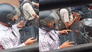 Red Light Workplace: ट्रैफिक सिग्नल पर बाइक पर बैठे-बैठे खोल लिया लैपटॉप, वायरल वीडियो ने उठाये वर्क कल्चर पर सवाल